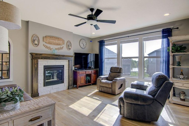 14485 S Houston St, Olathe, KS 66061 - living room with light wood-style floors, ceiling fan, a stone fireplace, and recessed lighting