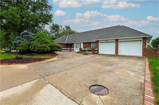 4406 S Stonecrest Cir, Saint Joseph, MO 64506 - view of front of home featuring an attached garage, brick siding, driveway, and a shingled roof