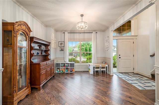 10601 N Euclid Ave, Kansas City, MO 64155 - entrance foyer with a chandelier, dark wood-style flooring, ornamental molding, and a wainscoted wall