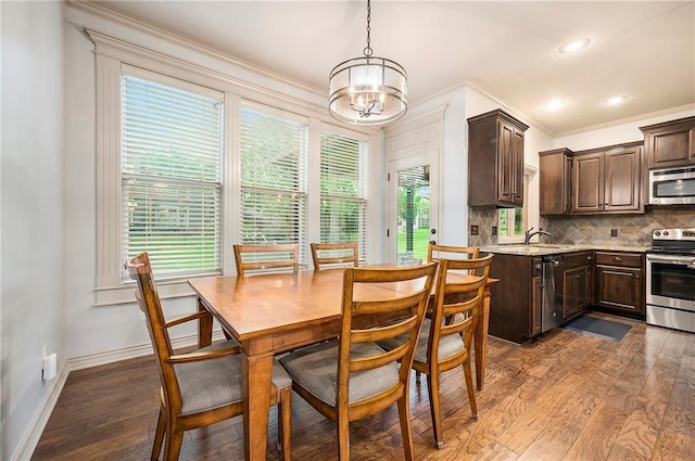 10601 N Euclid Ave, Kansas City, MO 64155 - dining room featuring a chandelier, ornamental molding, dark wood-type flooring, healthy amount of natural light, and recessed lighting