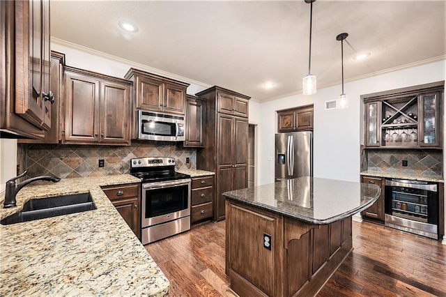 10601 N Euclid Ave, Kansas City, MO 64155 - kitchen featuring stainless steel appliances, a sink, wine cooler, dark brown cabinets, and a center island
