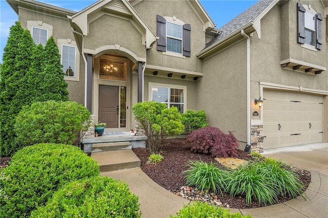 10601 N Euclid Ave, Kansas City, MO 64155 - view of front of home featuring stucco siding, an attached garage, and driveway