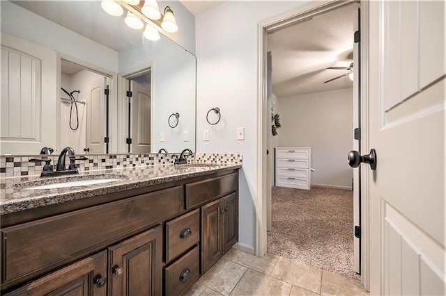 10601 N Euclid Ave, Kansas City, MO 64155 - bathroom featuring double vanity, ceiling fan, decorative backsplash, baseboards, and tile patterned flooring