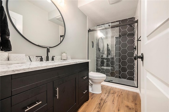 10601 N Euclid Ave, Kansas City, MO 64155 - bathroom with vanity, a stall shower, toilet, and wood finished floors