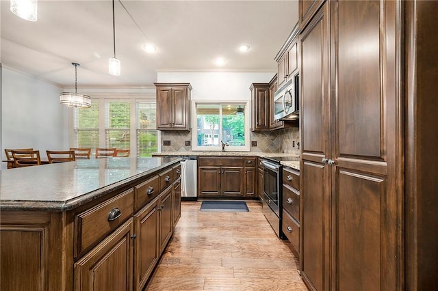 10601 N Euclid Ave, Kansas City, MO 64155 - kitchen with appliances with stainless steel finishes, ornamental molding, light wood-type flooring, backsplash, and healthy amount of natural light