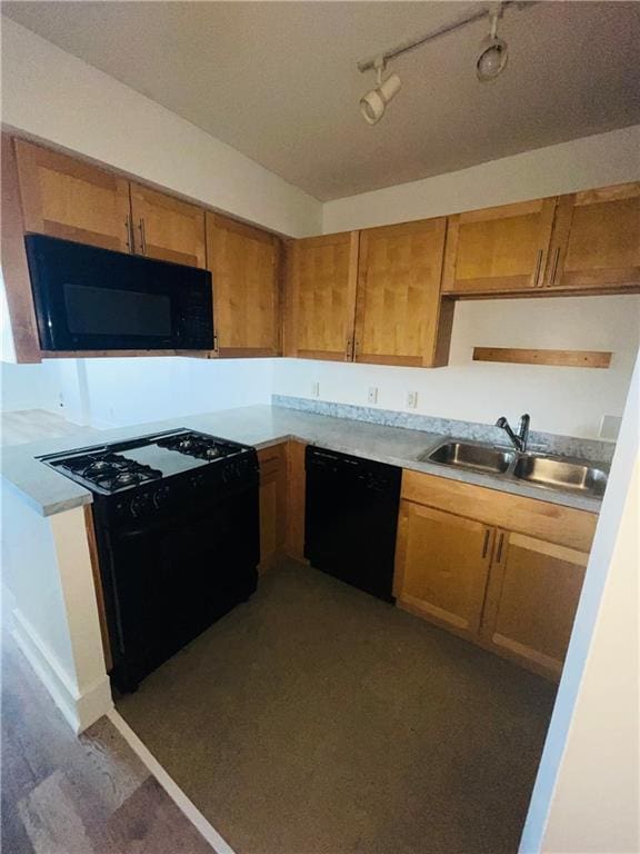 600 E 8th St Unit 11L, Kansas City, MO 64106 - kitchen with black appliances, a sink, rail lighting, brown cabinetry, and light countertops