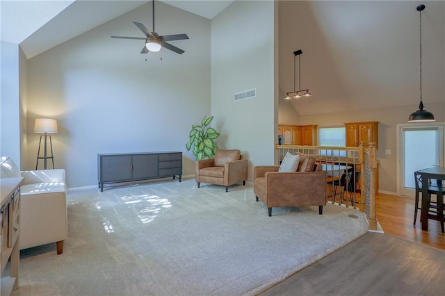 7500 N Oakland Ave, Kansas City, MO 64158 - living room featuring high vaulted ceiling, ceiling fan, baseboards, and light wood-style floors