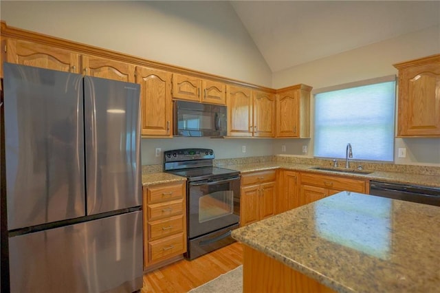 7500 N Oakland Ave, Kansas City, MO 64158 - kitchen with black appliances, a sink, vaulted ceiling, light wood-type flooring, and light stone countertops