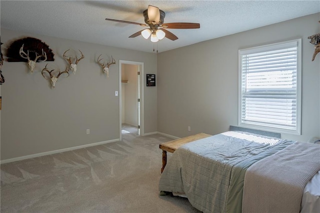 7500 N Oakland Ave, Kansas City, MO 64158 - bedroom featuring light carpet, baseboards, a ceiling fan, and a textured ceiling