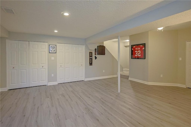 7500 N Oakland Ave, Kansas City, MO 64158 - finished basement with wood finished floors, baseboards, recessed lighting, a textured ceiling, and stairs