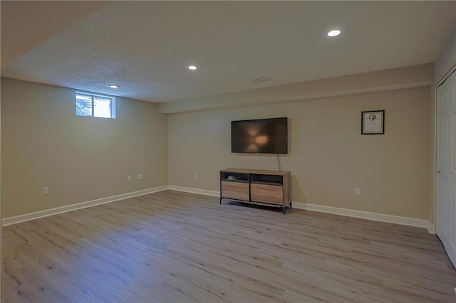 7500 N Oakland Ave, Kansas City, MO 64158 - basement with wood finished floors, recessed lighting, baseboards, and a textured ceiling