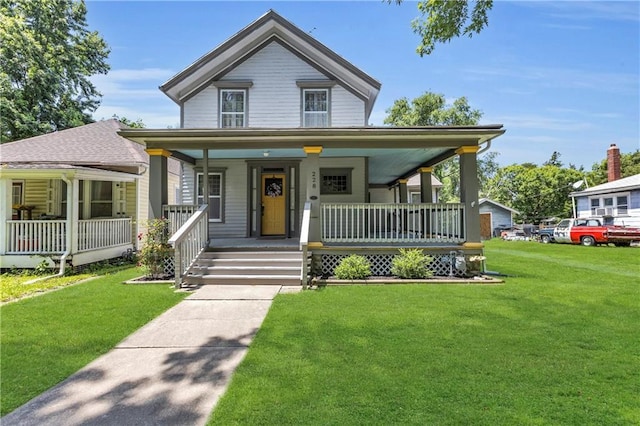 228 S Elm St, Ottawa, KS 66067 - view of front of house featuring a porch and a front yard