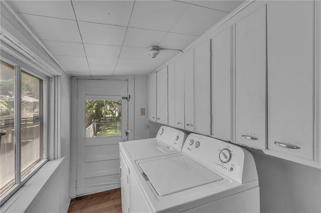 228 S Elm St, Ottawa, KS 66067 - laundry room with washer and clothes dryer, dark wood-style floors, and cabinet space
