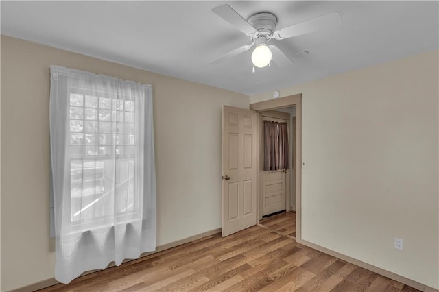 228 S Elm St, Ottawa, KS 66067 - spare room featuring ceiling fan, light wood-style flooring, and baseboards