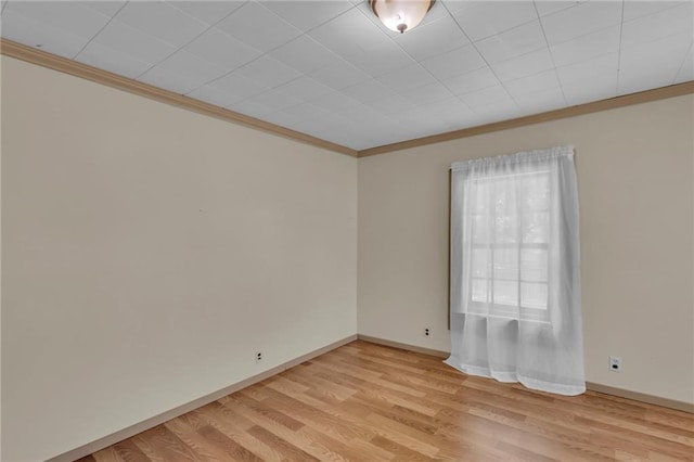 228 S Elm St, Ottawa, KS 66067 - empty room with ornamental molding, light wood finished floors, and baseboards