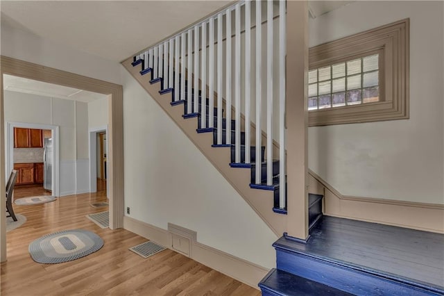 228 S Elm St, Ottawa, KS 66067 - staircase featuring wood finished floors and baseboards