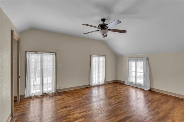 228 S Elm St, Ottawa, KS 66067 - unfurnished living room with vaulted ceiling, a ceiling fan, wood finished floors, and baseboards