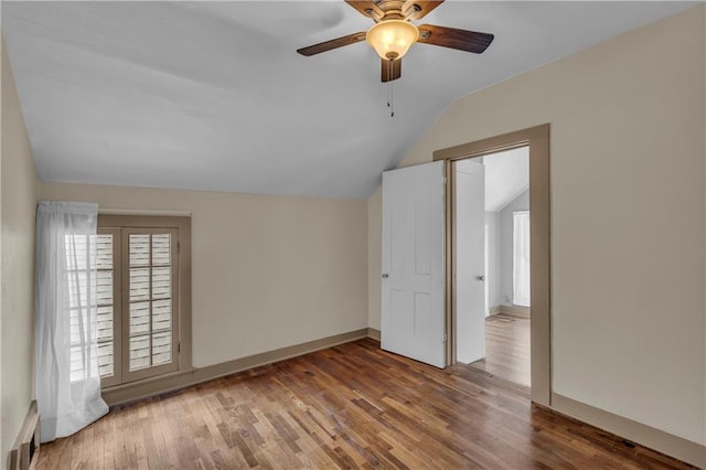 228 S Elm St, Ottawa, KS 66067 - bonus room with lofted ceiling, a ceiling fan, wood finished floors, and baseboards