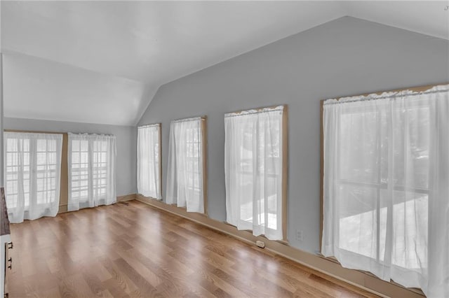 228 S Elm St, Ottawa, KS 66067 - empty room featuring vaulted ceiling and wood finished floors