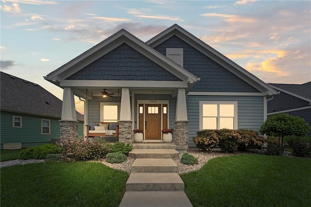 3205 SW Mary St, Lees Summit, MO 64081 - craftsman-style house with a porch, a front yard, and stone siding