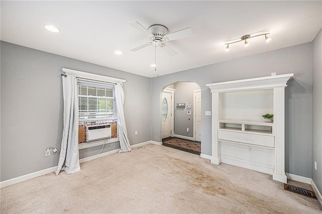 614 S 7th St, Atchison, KS 66002 - foyer featuring arched walkways, carpet floors, cooling unit, a ceiling fan, and baseboards