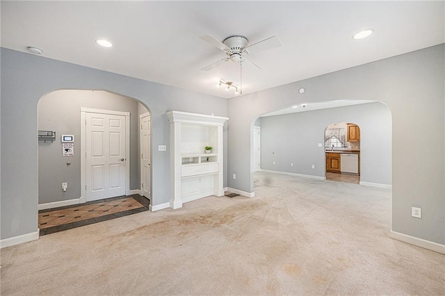 614 S 7th St, Atchison, KS 66002 - unfurnished room featuring arched walkways, ceiling fan, carpet floors, baseboards, and recessed lighting