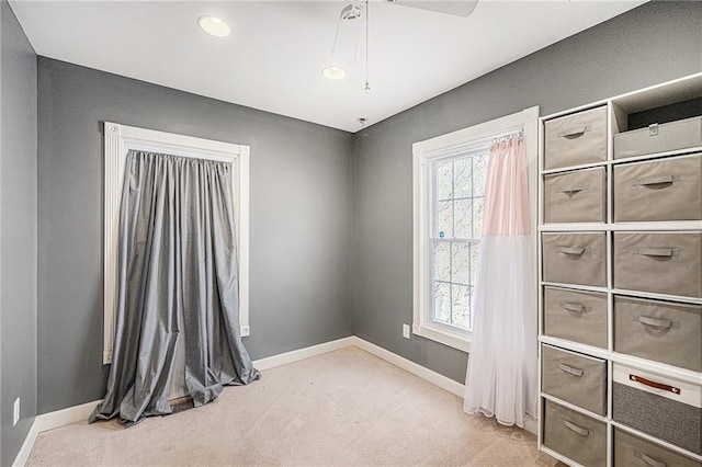 614 S 7th St, Atchison, KS 66002 - unfurnished bedroom featuring light colored carpet, multiple windows, baseboards, and recessed lighting