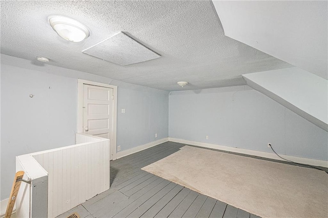 614 S 7th St, Atchison, KS 66002 - bonus room with baseboards, wood finished floors, and a textured ceiling