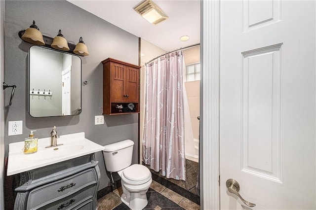 614 S 7th St, Atchison, KS 66002 - bathroom featuring vanity, toilet, shower / bath combination with curtain, and baseboards