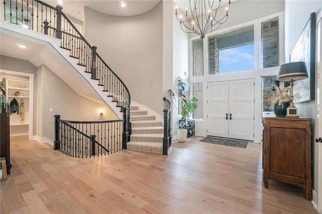 4112 W 156th St, Overland Park, KS 66224 - foyer with a high ceiling, wood finished floors, a chandelier, baseboards, and recessed lighting
