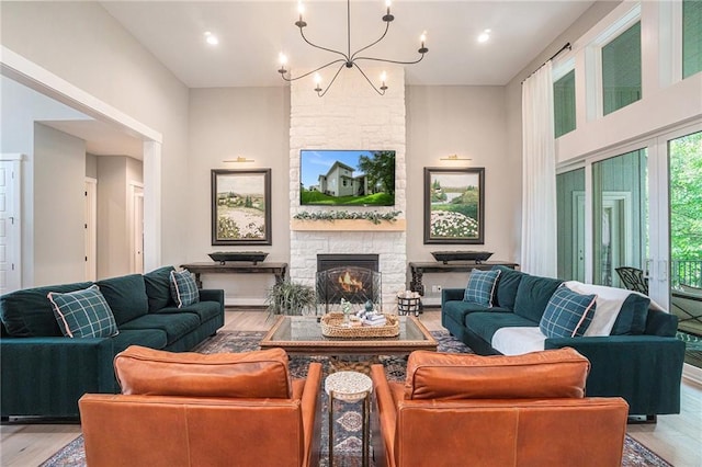 4112 W 156th St, Overland Park, KS 66224 - living area with light wood-style floors, a chandelier, a fireplace, and recessed lighting
