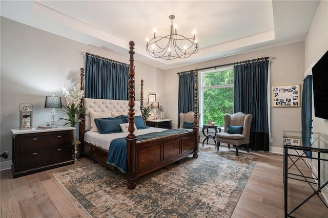 4112 W 156th St, Overland Park, KS 66224 - bedroom with a tray ceiling, a chandelier, wood finished floors, and baseboards
