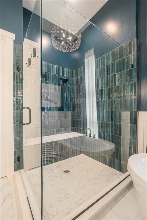 4112 W 156th St, Overland Park, KS 66224 - bathroom featuring marble look tiles, a shower stall, and a chandelier