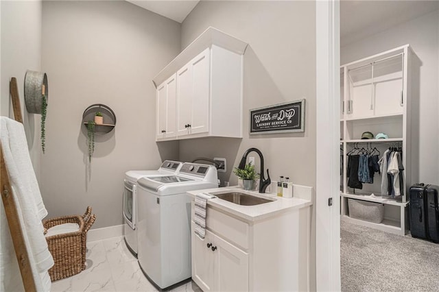4112 W 156th St, Overland Park, KS 66224 - laundry area with cabinet space, washing machine and clothes dryer, light marble finish floors, and baseboards