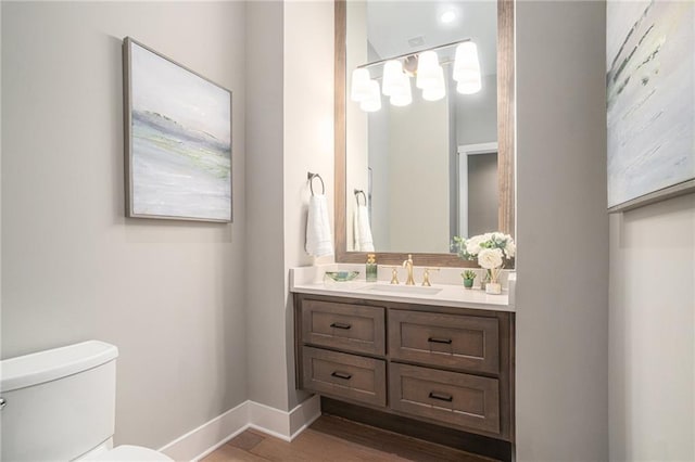 4112 W 156th St, Overland Park, KS 66224 - bathroom featuring toilet, vanity, baseboards, and wood finished floors