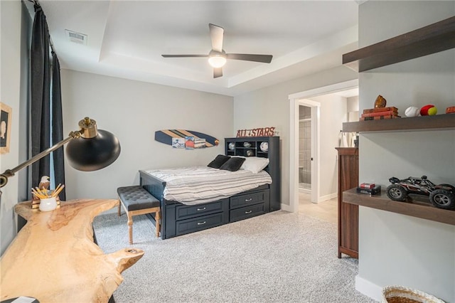 4112 W 156th St, Overland Park, KS 66224 - bedroom featuring a raised ceiling, light colored carpet, ensuite bath, and ceiling fan