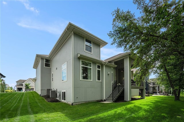 4112 W 156th St, Overland Park, KS 66224 - rear view of property featuring a yard, stairs, and central air condition unit