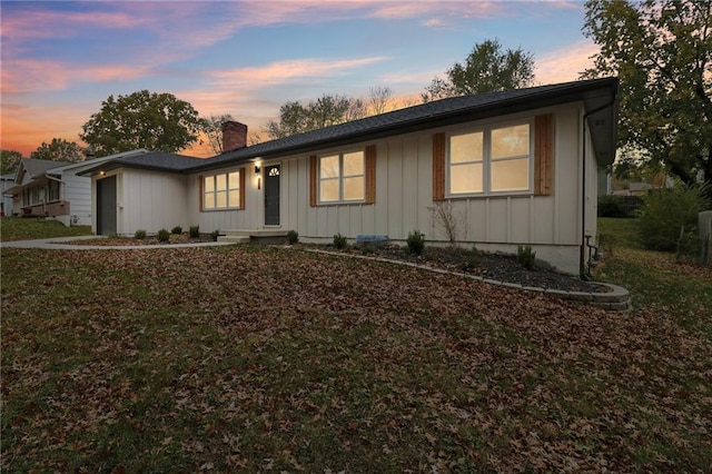 618 E 108th Ter, Kansas City, MO 64131 - ranch-style house with board and batten siding and a chimney