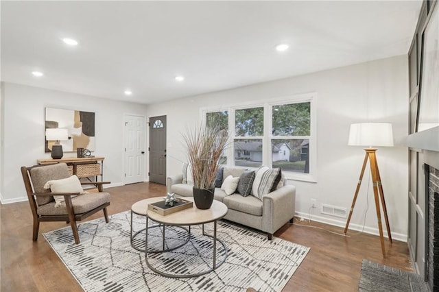 618 E 108th Ter, Kansas City, MO 64131 - living area featuring a fireplace with flush hearth, baseboards, wood finished floors, and recessed lighting