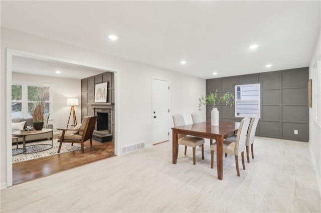 618 E 108th Ter, Kansas City, MO 64131 - dining space with recessed lighting, a fireplace with raised hearth, and baseboards