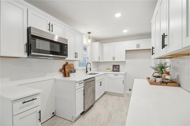 618 E 108th Ter, Kansas City, MO 64131 - kitchen with appliances with stainless steel finishes, a sink, backsplash, recessed lighting, and decorative light fixtures