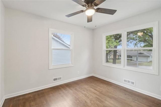 618 E 108th Ter, Kansas City, MO 64131 - unfurnished room with baseboards, dark wood-style flooring, plenty of natural light, and ceiling fan