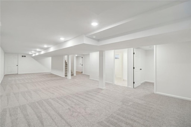 618 E 108th Ter, Kansas City, MO 64131 - finished below grade area with light colored carpet, baseboards, recessed lighting, and stairs