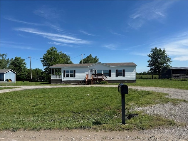 516 E 614th St, Girard, KS 66743 - manufactured / mobile home with curved driveway and a front lawn