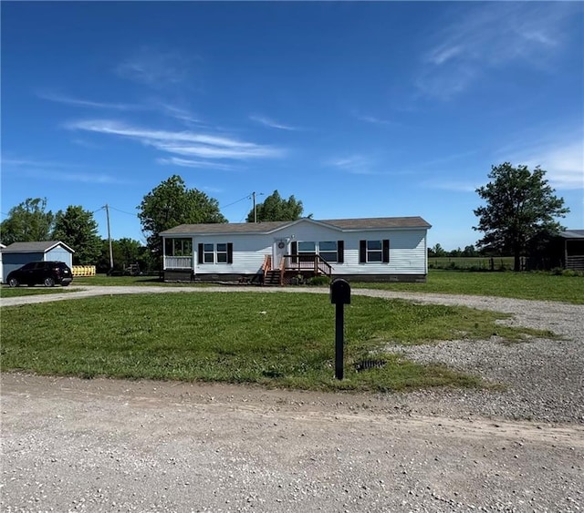 516 E 614th St, Girard, KS 66743 - manufactured / mobile home with driveway and a front lawn