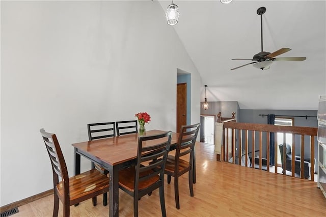 14713 W 149th Ct, Olathe, KS 66062 - dining space with vaulted ceiling, a ceiling fan, and light wood-style floors