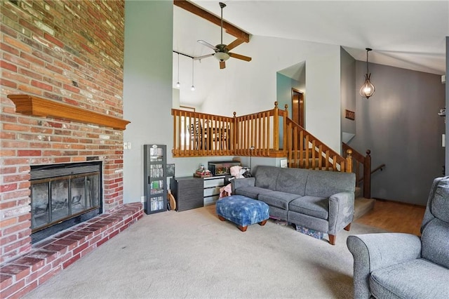 14713 W 149th Ct, Olathe, KS 66062 - living room featuring high vaulted ceiling, stairs, a ceiling fan, a brick fireplace, and beamed ceiling