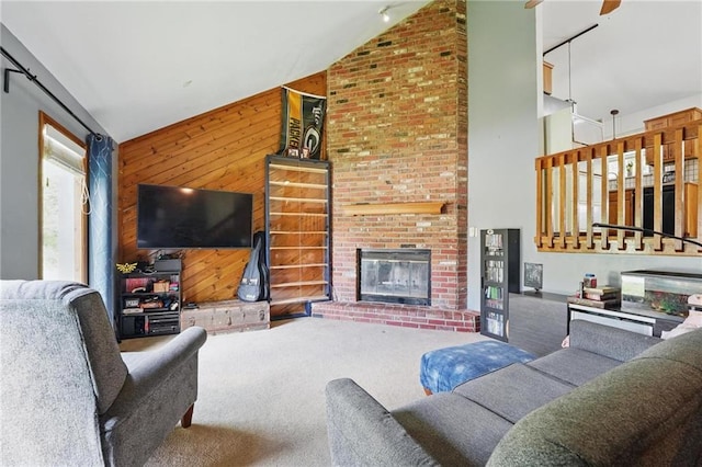 14713 W 149th Ct, Olathe, KS 66062 - living area with high vaulted ceiling, carpet, wooden walls, a ceiling fan, and a fireplace
