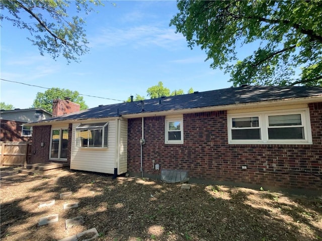15405 E 40th St, Independence, MO 64055 - rear view of house featuring brick siding and a chimney