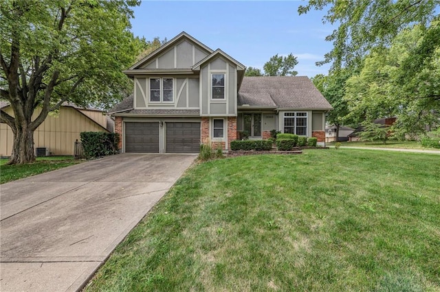 13303 W 102nd St, Lenexa, KS 66215 - tudor house with brick siding, an attached garage, driveway, and a front lawn